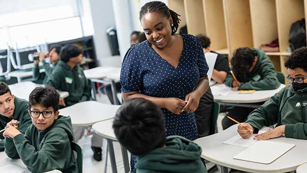 similing teacher talking to student